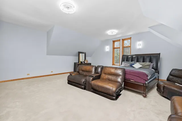 a spacious bedroom with a bed and couch