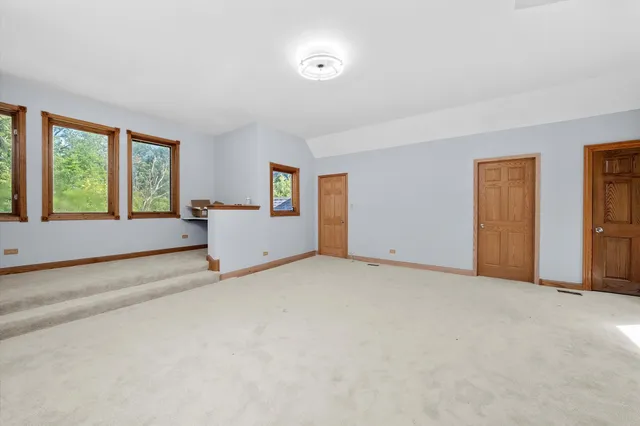 a view of an empty room with window and a livingroom