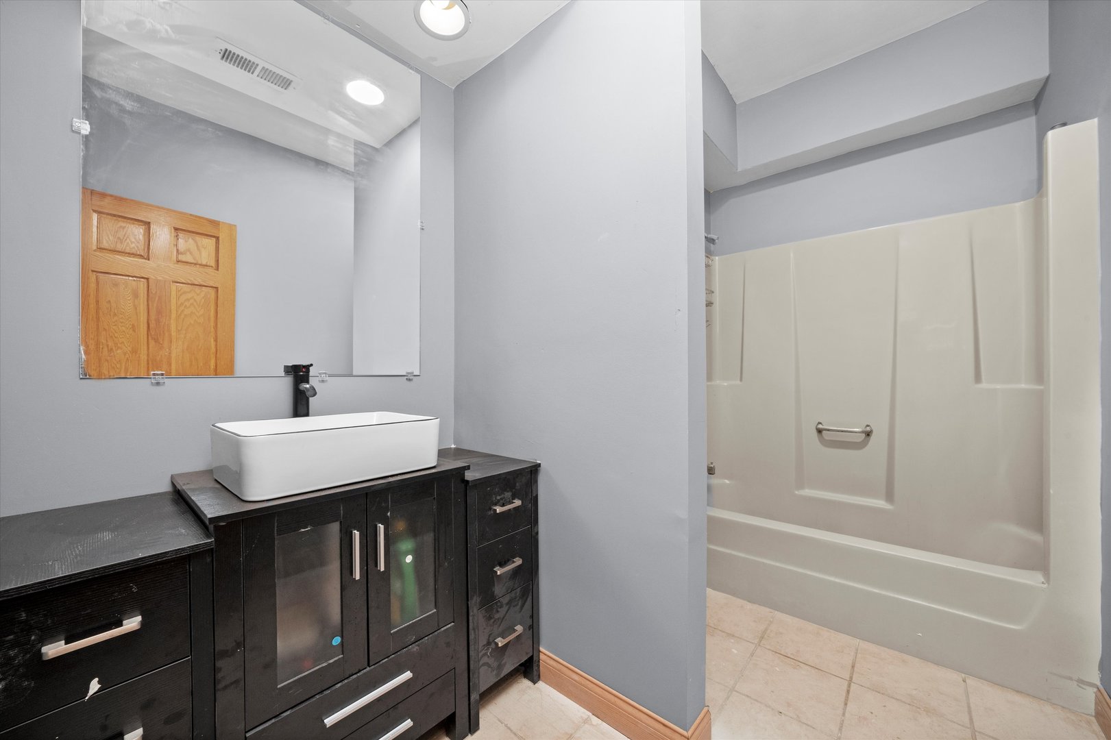 3755 South State Street Crete, IL 60417 - Photo 31 of 48 a bathroom with a sink a shower and a mirror