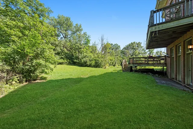 a view of a house with a backyard