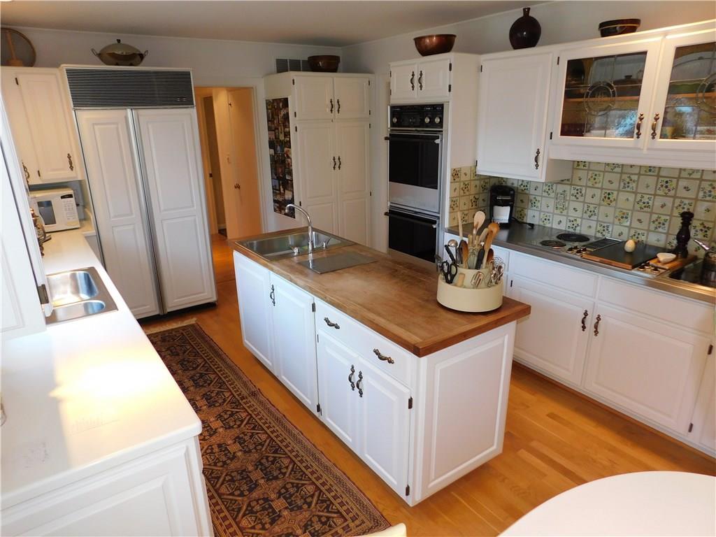 286 Donation Road Greenville, PA 16125 - Photo 11 of 25 WHITE GALLEY KITCHEN WITH ISLAND AND EXTRA PREP SINK/JEN AIR DOWN DRAFT GRILL, BUILT IN DOUBLE OVENS, CORIAN COUNTER, SUBZERO FRIG.