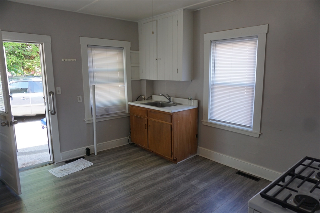 5-7 Summer Street Maynard, MA 01754 - Photo 4 of 28 a kitchen with stainless steel appliances granite countertop a stove and a refrigerator