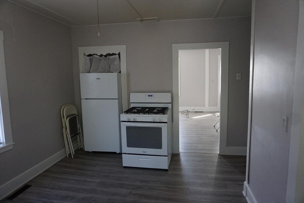 5-7 Summer Street Maynard, MA 01754 - Photo 6 of 28 a kitchen with a refrigerator and a stove top oven
