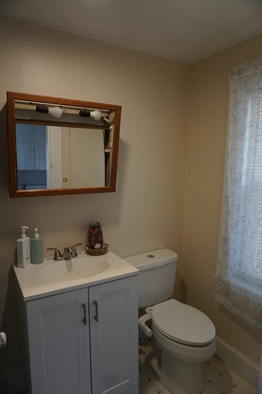 5-7 Summer Street Maynard, MA 01754 - Photo 7 of 28 a bathroom with a toilet a sink and mirror