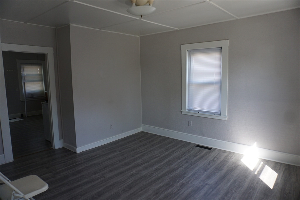 5-7 Summer Street Maynard, MA 01754 - Photo 10 of 28 an empty room with wooden floor and windows