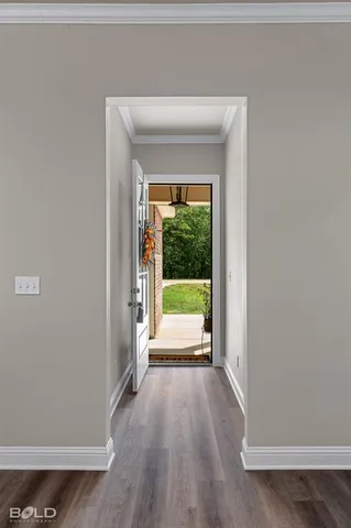 a view of an empty room and wooden floor