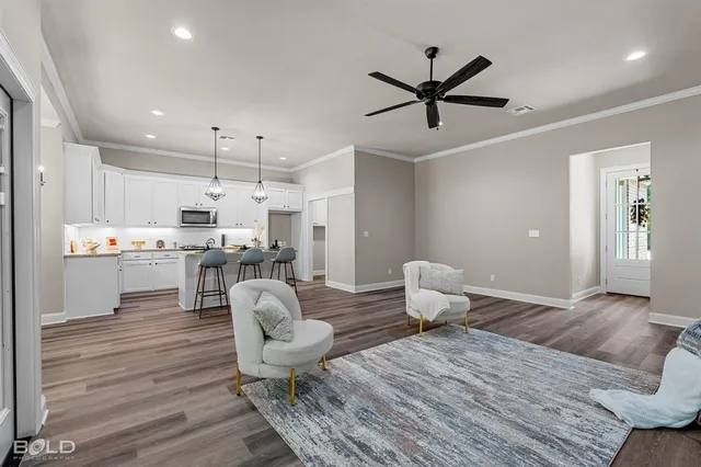 a living room with kitchen island furniture and a wooden floor