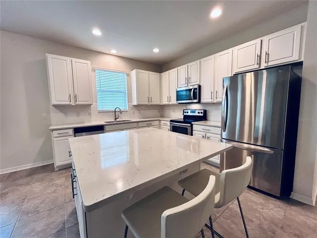 a kitchen with a sink a stove and cabinets