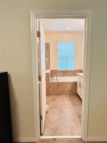 a view of roof with floor to ceiling window next to a yard