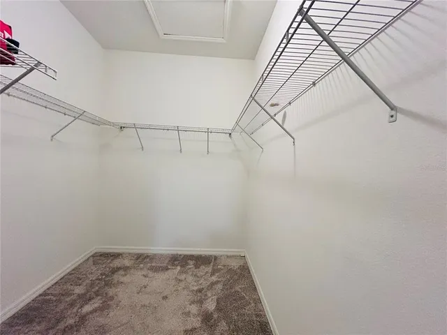 a aerial view of a large building with potted plants and big yard