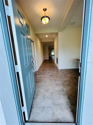 a view of a hallway to rooms