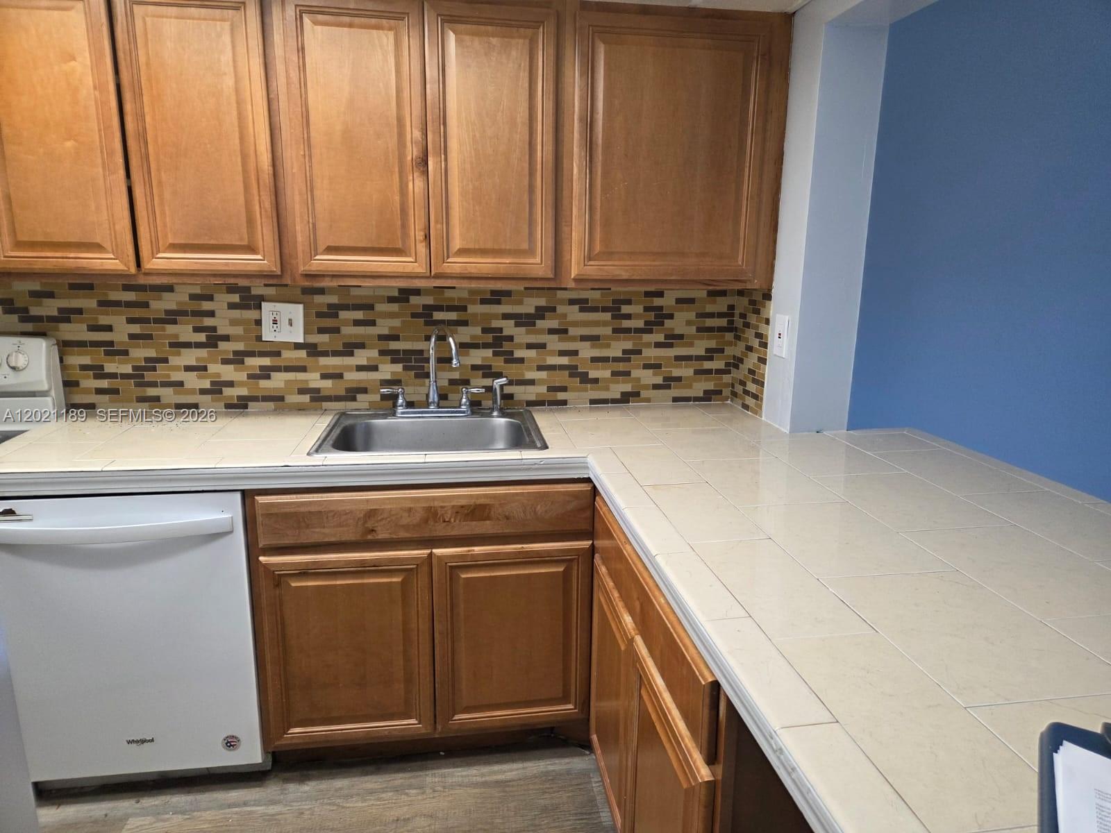 8060 North Colony Circle, Unit 103 Tamarac, FL 33321 - Photo 1 of 8 a view of a kitchen with a sink