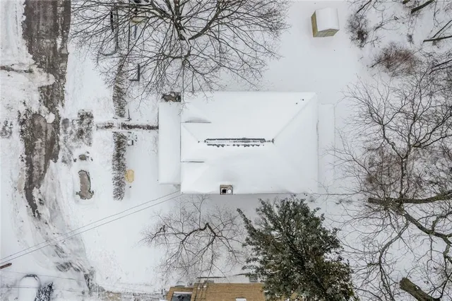 an aerial view of house with yard and mountain view in back