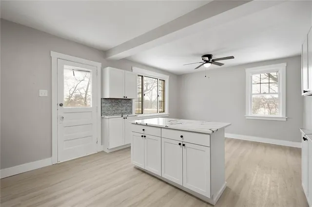 a view of a kitchen with a sink dishwasher and wooden floor