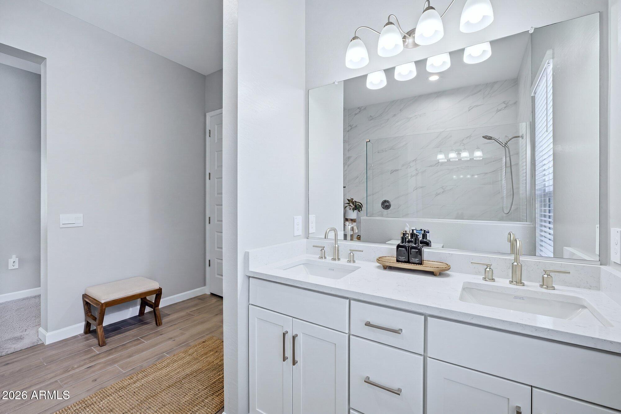5963 East Lone Cactus Road Phoenix, AZ 85054 - Photo 13 of 22 a bathroom with a sink vanity and a mirror