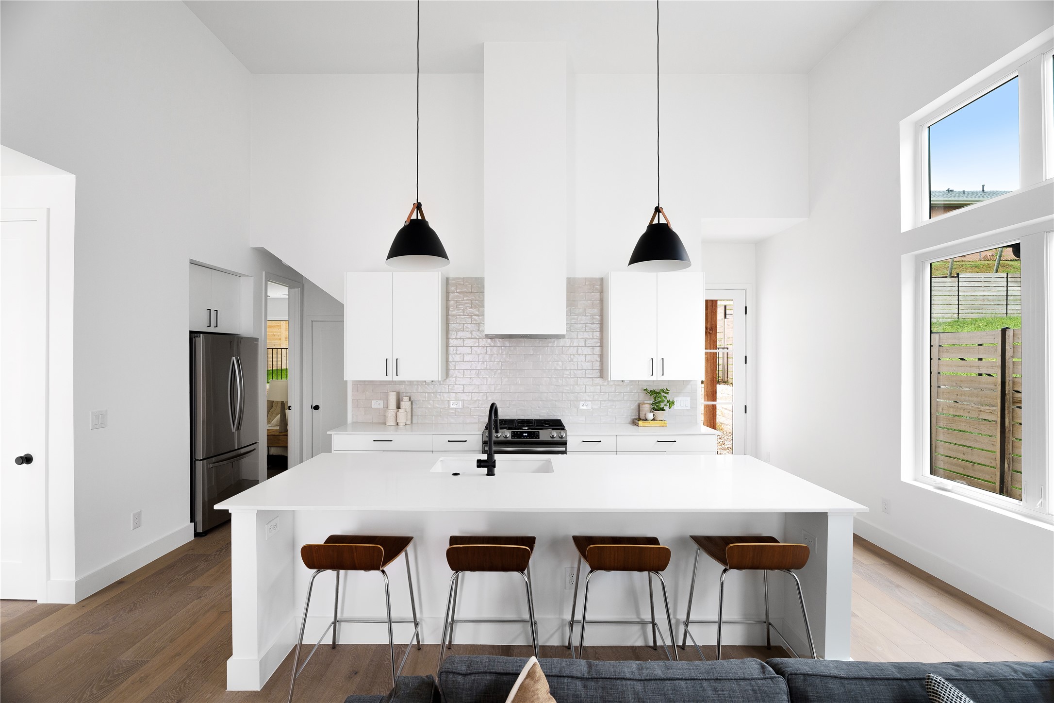 a kitchen with a sink a stove and chairs