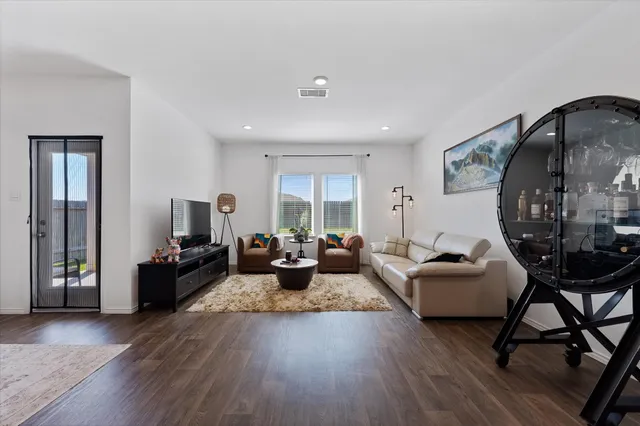 a living room with fireplace furniture and a wooden floor