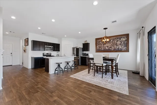 a view of a dining room kitchen with furniture and wooden floor