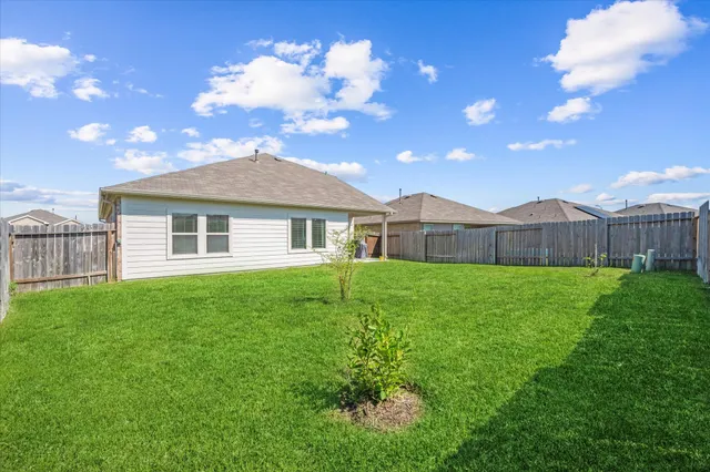 a view of an house with backyard space and garden
