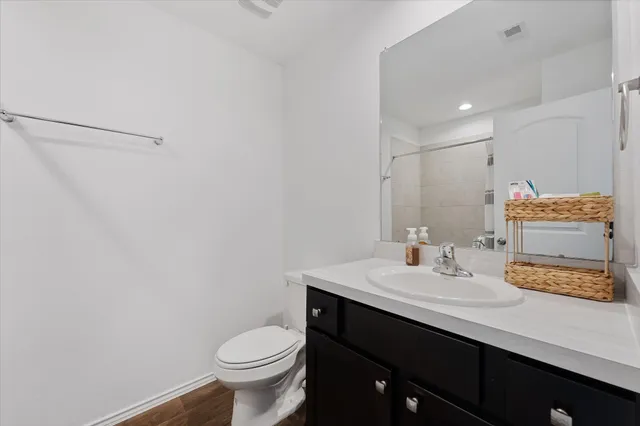 a bathroom with a sink toilet and vanity