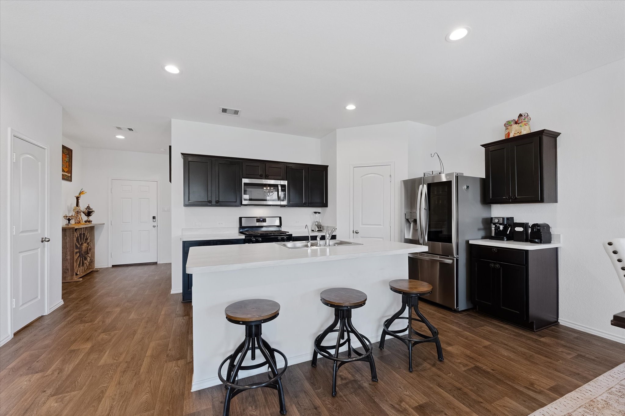 21511 Violet Rdg Road Katy, TX 77449 - Photo 10 of 27 a kitchen with stainless steel appliances a stove top oven a refrigerator a sink and a refrigerator