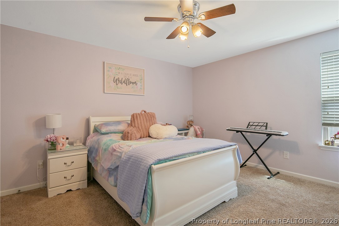 340 Battery Way Bunnlevel, NC 28323 - Photo 39 of 50 a bedroom with a bed and a chandelier