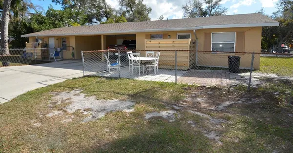 a view of a house with backyard and a patio