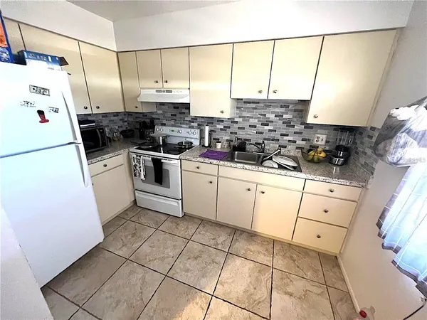 a kitchen with a sink a stove and refrigerator