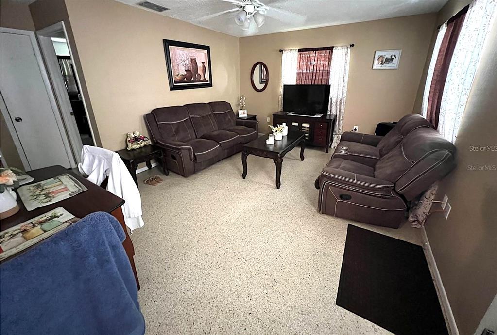 2100 9th Street Sarasota, FL 34237 - Photo 9 of 11 a living room with furniture a couch and a flat screen tv