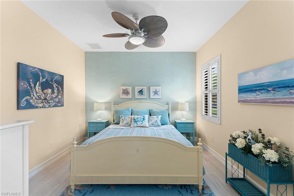 8838 Lely Island Circle Naples, FL 34113 - Photo 20 of 47 a bed sitting in a bedroom next to a window