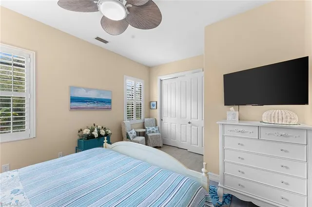 a bedroom with a bed and flat screen tv