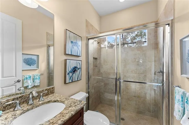 a bathroom with a granite countertop tub shower sink and mirror