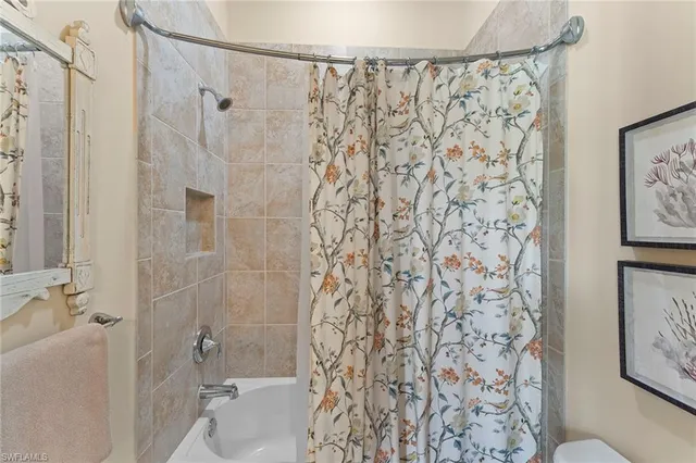 a bathroom with a shower curtain and a shower curtain