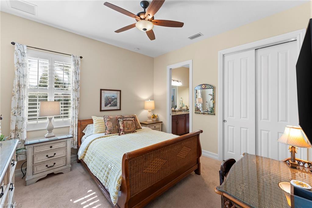 8838 Lely Island Circle Naples, FL 34113 - Photo 30 of 47 a bedroom with a bed and wooden floor