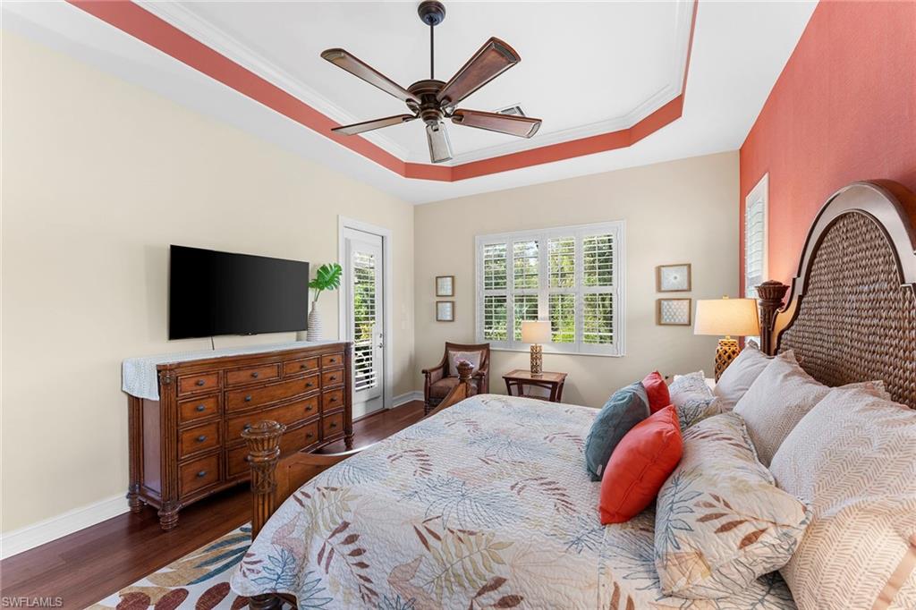 8838 Lely Island Circle Naples, FL 34113 - Photo 33 of 47 a bedroom with a bed and a flat screen tv