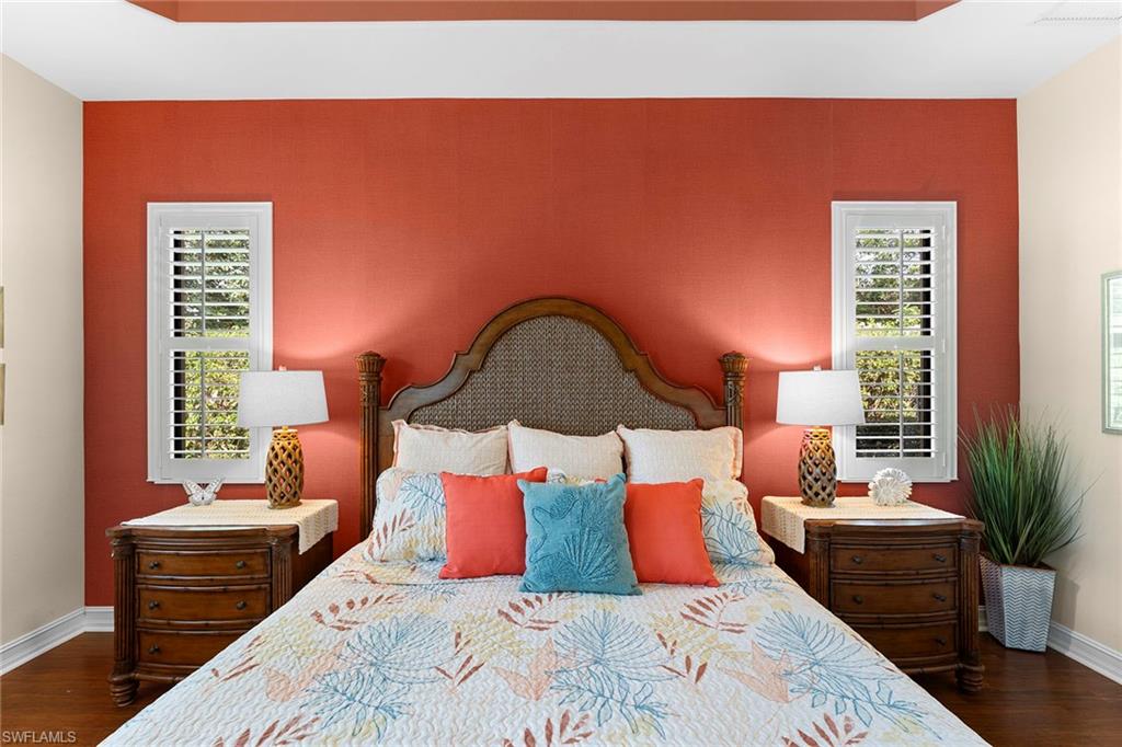8838 Lely Island Circle Naples, FL 34113 - Photo 34 of 47 a bedroom with a bed lamp and a potted plant