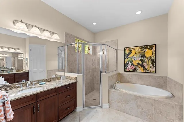 a bathroom with a tub a sink and mirror