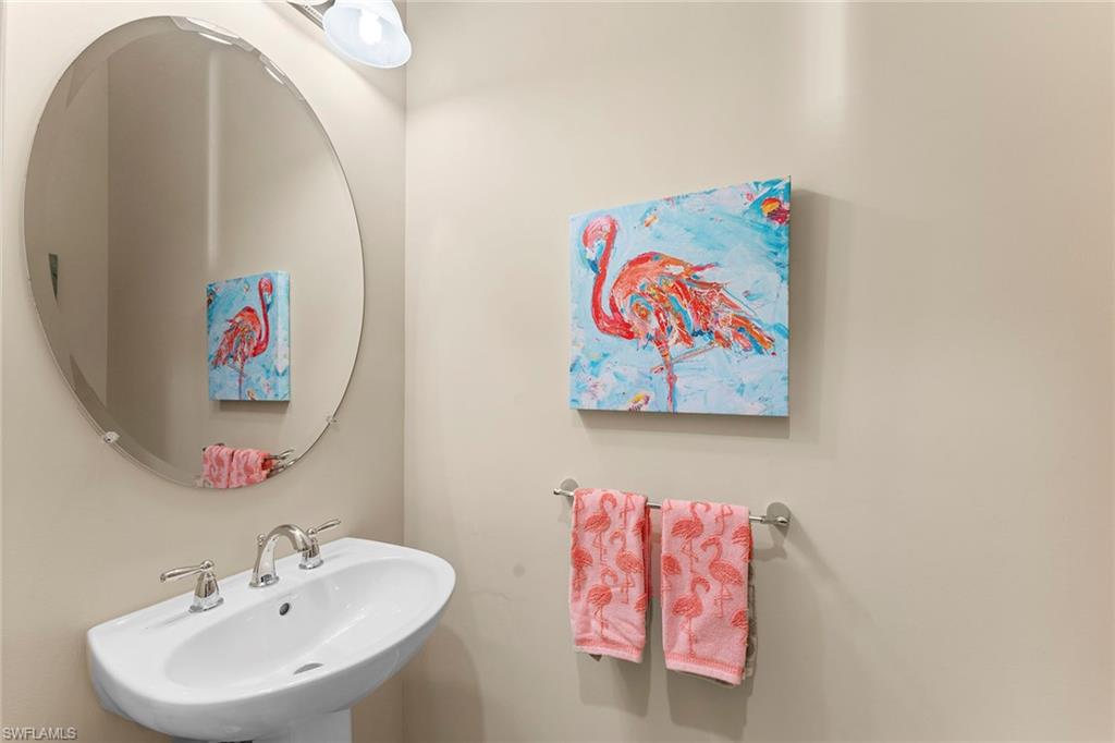 8838 Lely Island Circle Naples, FL 34113 - Photo 37 of 47 a bathroom with a sink and a mirror