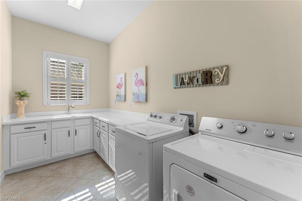 8838 Lely Island Circle Naples, FL 34113 - Photo 39 of 47 a utility room with dryer and washer