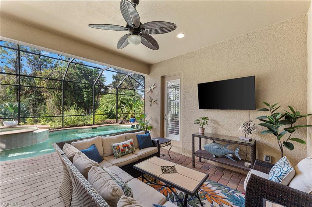 8838 Lely Island Circle Naples, FL 34113 - Photo 42 of 47 a living room with furniture tv and a large window