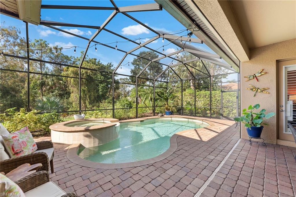 8838 Lely Island Circle Naples, FL 34113 - Photo 43 of 47 a view of a swimming pool with a patio