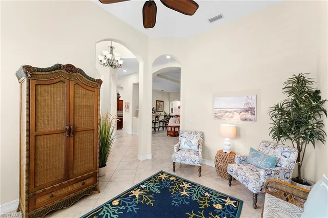 a living room with furniture and a chandelier