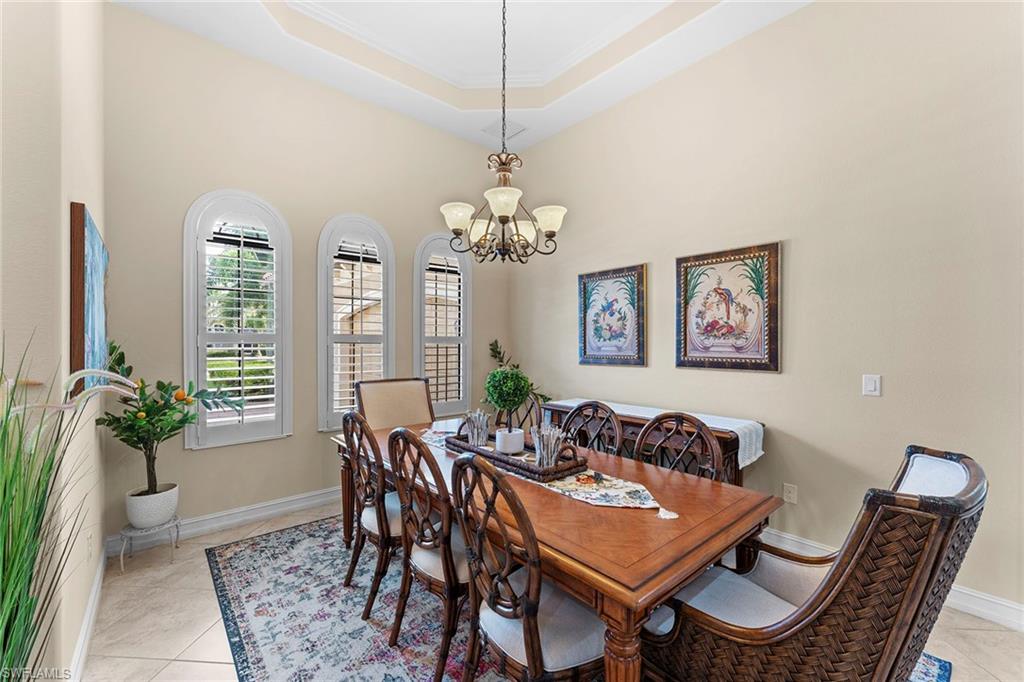 8838 Lely Island Circle Naples, FL 34113 - Photo 7 of 47 a dining room with furniture and window