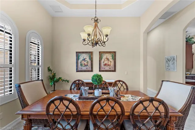 a view of a dining room with furniture wooden floor and a chandelier