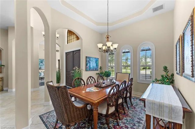 a dining room with furniture a chandelier and a rug