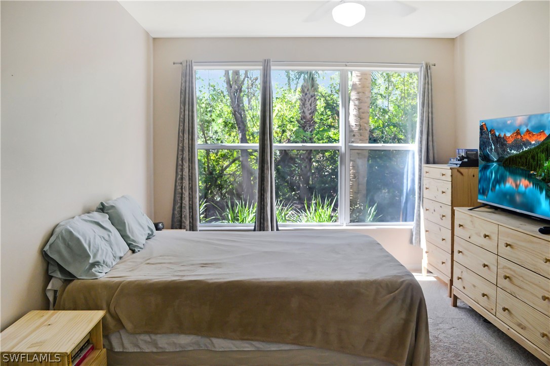 9048 Triangle Palms Lane, Unit 1106 Fort Myers, FL 33913 - Photo 13 of 29 a bed sitting in a bedroom next to a window