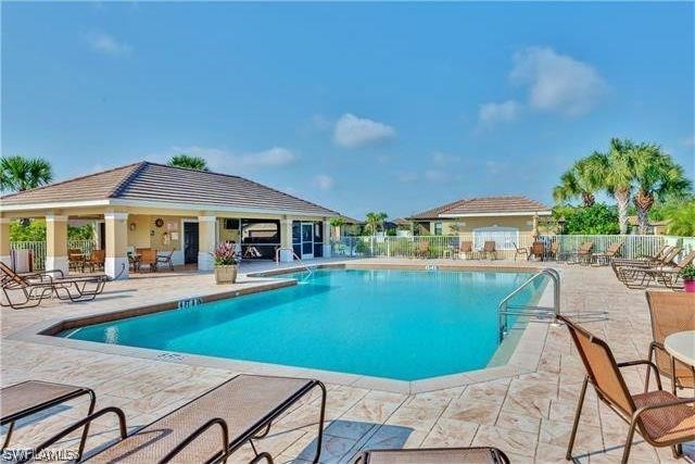 9048 Triangle Palms Lane, Unit 1106 Fort Myers, FL 33913 - Photo 29 of 29 a view of house with swimming pool outdoor seating area and barbeque oven