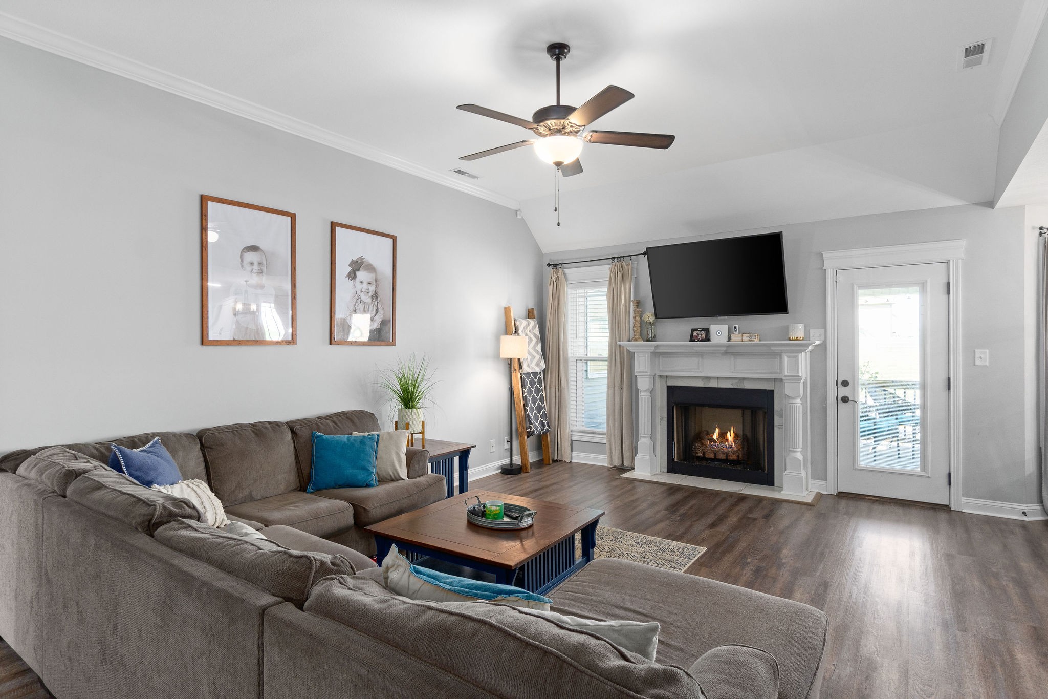 1036 Rushmore Road Clarksville, TN 37042 - Photo 3 of 32 a living room with furniture a flat screen tv and a fireplace