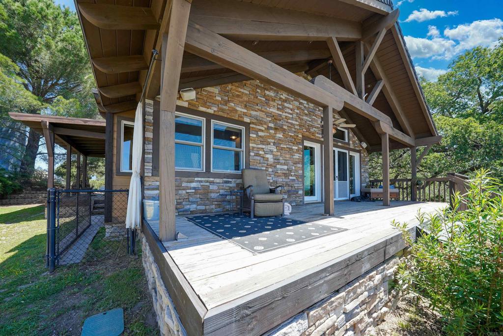 21057 Sutherland Dam Road Ramona, CA 92065 - Photo 16 of 66 a view of house with backyard outdoor seating and hardwood