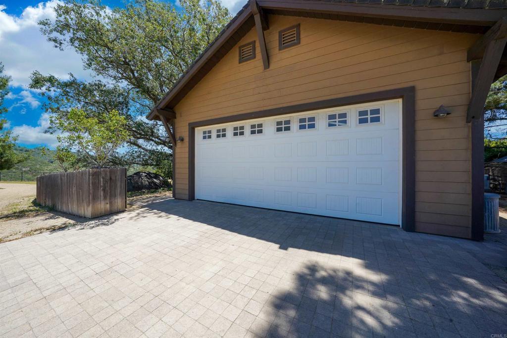 21057 Sutherland Dam Road Ramona, CA 92065 - Photo 19 of 66 a front view of a house with a garage